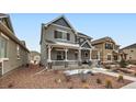 Beautiful two-story home with a covered front porch, and a well-maintained front yard at 668 Sage Forest Ln, Monument, CO 80132