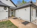 View of the front exterior with a well-kept lawn, charming walkway, and a single-car garage on a sunny day at 4723 S Pagosa Way, Aurora, CO 80015