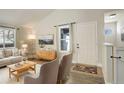 Bright living room featuring mid-century furniture and hardwood floors at 4723 S Pagosa Way, Aurora, CO 80015