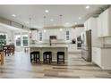 Bright kitchen with an island, sleek stainless steel appliances, granite countertops, and ample cabinet space at 6630 S Coolidge Ct, Aurora, CO 80016
