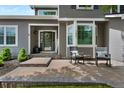 Charming front porch with rocking chairs, creating a welcoming entrance to this lovely home at 7027 Chestnut Hill St, Highlands Ranch, CO 80130