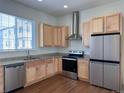 Bright kitchen features stainless steel appliances, granite counters, and light wood cabinets at 8311 Parkland St, Broomfield, CO 80021