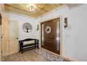 Inviting foyer with wood-look floors, featuring a charming bench and decorative accents at 28251 Shadow Mountain Dr, Conifer, CO 80433