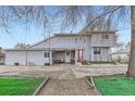 Charming front exterior featuring a red front door, covered porch and low maintenance yard at 195 Briggs St, Erie, CO 80516