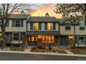 Attractive townhouse showcases brick accents, a welcoming porch, and professional landscaping at 7068 E Briarwood Dr, Centennial, CO 80112