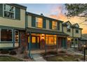 Inviting townhouse exterior with brick facade, covered porch, and cozy curb appeal at 7068 E Briarwood Dr, Centennial, CO 80112