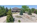 Expansive home featuring a lush lawn and meticulously landscaped front yard at 9353 E 146Th Ave, Brighton, CO 80602