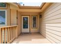 Charming front porch with a light-colored wooden deck, offering a cozy and inviting entrance to the home at 10478 W 82Nd Ave, Arvada, CO 80005
