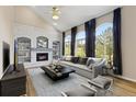 Bright living room with a fireplace, built-in shelves, and large windows at 20816 E Shefield Pl, Parker, CO 80138