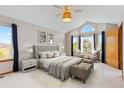 Cozy main bedroom with a seating area, large windows, and a ceiling fan at 20816 E Shefield Pl, Parker, CO 80138