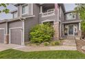 Charming home featuring stone pillars and walkway, complemented by lush landscaping and a welcoming entrance at 10230 Lauren Ct, Highlands Ranch, CO 80130