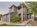 Charming home featuring stone pillars and walkway, complemented by lush landscaping and a welcoming entrance at 10230 Lauren Ct, Highlands Ranch, CO 80130