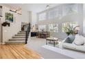 Bright, open-concept living and dining area with soaring ceilings and large windows at 10230 Lauren Ct, Highlands Ranch, CO 80130