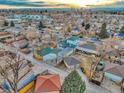 Expansive aerial view of the neighborhood showcasing rooftops and distant city skyline at sunset at 3550 Eudora St, Denver, CO 80207