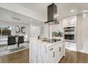 Bright, modern kitchen with island, stainless steel appliances, and sleek white cabinetry at 3550 Eudora St, Denver, CO 80207