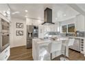 Modern kitchen featuring a center island with marble countertop, stainless steel appliances, and sleek cabinetry at 3550 Eudora St, Denver, CO 80207
