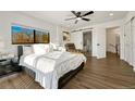 Bright main bedroom with a large window, modern decor, and ensuite bathroom with a soaking tub at 3550 Eudora St, Denver, CO 80207