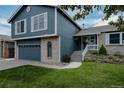 Charming two-story home with an attached garage, updated siding, and a well-maintained front yard at 6386 S Pierson St, Littleton, CO 80127