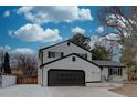 Charming two-story home featuring a brick exterior, a well-manicured lawn, and a two-car garage at 7249 S Iris Ct, Littleton, CO 80128