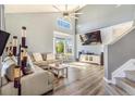 Bright living room featuring a modern sectional sofa, vaulted ceilings, and a large bay window for lots of natural light at 16160 E 119Th Ave, Commerce City, CO 80022