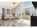 Spacious living room featuring two modern sofas, vaulted ceilings, and large windows for lots of natural light at 16160 E 119Th Ave, Commerce City, CO 80022
