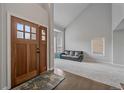 Bright living room with new carpet, large windows, and a stylish front door at 1769 W 113Th Ave, Denver, CO 80234