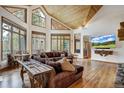 Spacious living area with wood floors, large windows, and a cozy sectional sofa at 47 Forest Cir, Breckenridge, CO 80424