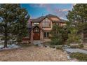 Charming home showcasing stone accents and a welcoming front entrance with mature trees at 47032 Frasier Fir Cir, Parker, CO 80138