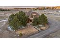 An elevated view of a single-Gathering home with mature landscaping in a tranquil, rural setting at 47032 Frasier Fir Cir, Parker, CO 80138