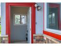 Inviting red trimmed doorway with stone accents and contemporary lighting at 1035 Quartz St, Golden, CO 80401