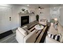 Bright living room featuring stylish furniture, a cozy fireplace, and a ceiling fan for added comfort at 16425 E 17Th Pl # A, Aurora, CO 80011