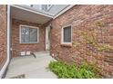 Welcoming brick entrance with a covered porch, leading to the front door at 7580 S Monaco Way, Centennial, CO 80112