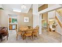 Cozy dining room with a wooden table set, open to the kitchen and living areas at 6534 S Union Way, Littleton, CO 80127