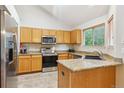 Well-equipped kitchen featuring stainless steel appliances, granite countertops, and ample cabinet space for storage at 6534 S Union Way, Littleton, CO 80127