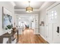 Bright foyer with hardwood floors, a stylish light fixture, and decorative columns at 2715 W 37Th Ave, Denver, CO 80211