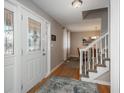 Bright entry with stained glass door and staircase at 8015 W Calhoun Pl, Littleton, CO 80123