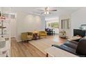 Bright living room with hardwood floors, modern lighting, and comfortable seating at 534 E 7Th Ave # 101, Denver, CO 80203