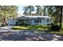 Classic single-story home with a well-manicured lawn, mature trees, and charming curb appeal creating a welcoming atmosphere at 5777 County Road 154, Elizabeth, CO 80107