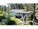 Two-story home with a spacious deck, complemented by lush greenery and landscaping offering both style and outdoor living space at 5777 County Road 154, Elizabeth, CO 80107