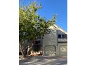 Two-story home featuring an attached two-car garage and a well-maintained front yard with a large tree at 5479 E Weaver Ave, Centennial, CO 80121