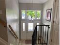 Inviting foyer with decorative glass door and sidelights, staircase with wrought iron railing, and high ceiling at 5479 E Weaver Ave, Centennial, CO 80121