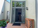 Elegant home featuring a stylish front door with glass detailing, flanked by decorative planters and modern lighting at 5479 E Weaver Ave, Centennial, CO 80121