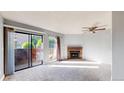 Bright living room featuring a fireplace and sliding glass door to a private patio at 12360 W Nevada Pl # 101, Lakewood, CO 80228