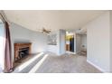 Inviting living room with brick fireplace and a view into the adjacent kitchen at 12360 W Nevada Pl # 101, Lakewood, CO 80228
