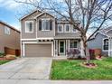 Charming two-story home with neutral siding, large front lawn, and an attached two-car garage at 9774 Burberry Way, Highlands Ranch, CO 80129
