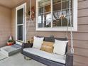 Cozy front porch with a welcoming porch swing and decorative floral wreath on the front door at 9774 Burberry Way, Highlands Ranch, CO 80129