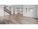 Bright living room featuring hardwood floors, large windows, and an open floor plan at 39713 Penn Rd, Elizabeth, CO 80107