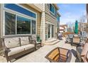 Relaxing outdoor patio with comfortable seating, hot tub, and a grill at 11636 Laurel Ln, Parker, CO 80138