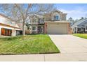 Charming two-story home with a well-manicured lawn, mature tree, and spacious driveway at 11636 Laurel Ln, Parker, CO 80138
