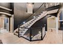 Elegant, winding staircase with a dark wood railing and white balusters at 6517 Perry Park Blvd, Larkspur, CO 80118